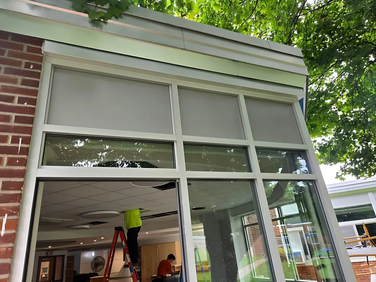 Aluminum entrance frame with glass transoms set into a brick wall