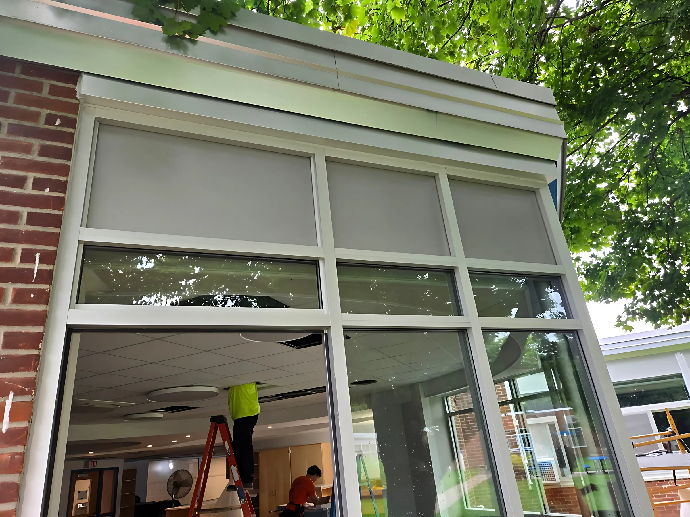 Aluminum entrance frame with glass transoms set into a brick wall